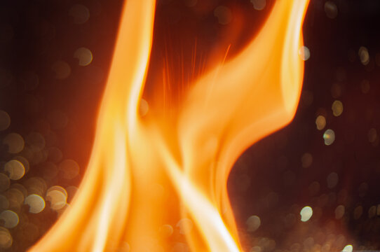 Flames dance in the night at a cozy bonfire gathering
