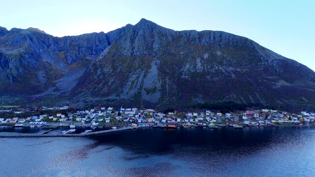 Aerial View of Gryllefjord Village Against Dramatic Steep Mountain on Senja Island Norway