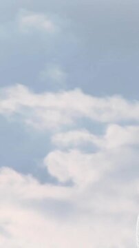 Animation of stone sculpture over sky with clouds