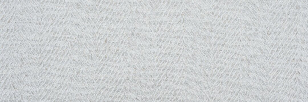 Herringbone white fabric texture background, light gray wool textile pattern with chevron weave, soft cotton material surface for fashion design and interior upholstery backdrop decor.