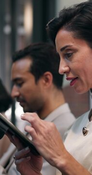 Woman, waiting or tablet in office for job interview, review CV or practice questions on AI website. Line, mature person and prepare in business for recruitment, meeting or candidate scroll with tech