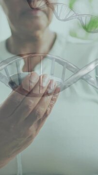 Animation of dna strands over senior african american woman using glucose meter