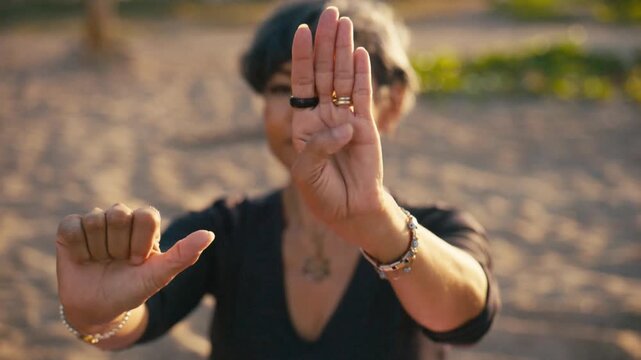 Mature woman practicing tai chi hands movement