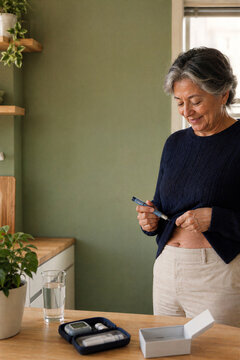 Senior woman using an insulin pen at home for diabetes management
