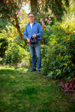 Full length of a senior mand gardening in a back yard