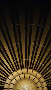 Art deco golden sunburst fan with rotating shell tiers, luxury vertical seamless loop background