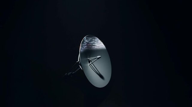 Panning shot rotating satellite dish reflecting light in dark studio setting with subtle motion blur and tracked camera movement