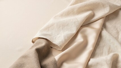 Fototapeta premium Fabric Texture Close-Up, Beige Linen Cloth with Folds and Wrinkles. Textile Background, Natural Material, Soft Drape.