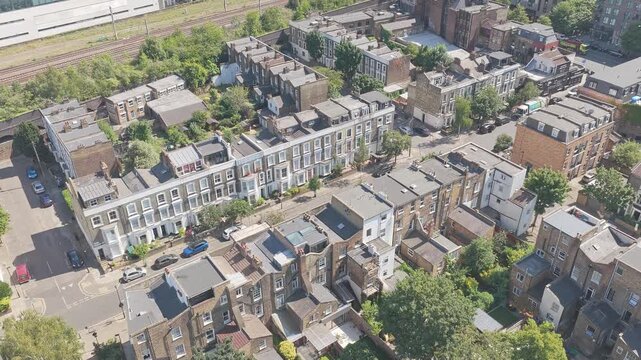 Aerial Drone Footage of elegant Victorian and Edwardian terraced houses near Arsenal FC's Emirates Stadium in North London, England. The aerial view moves closer and captures attractive period homes.