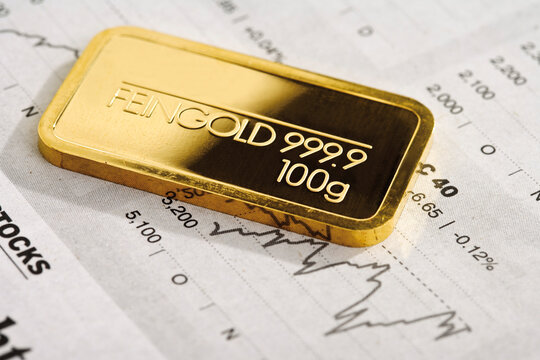 Gold bar and financial newspaper