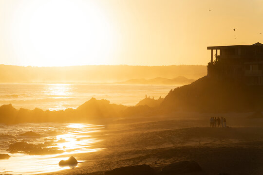 Golden sunset illuminates the Keurboomstrand beach in South Africa