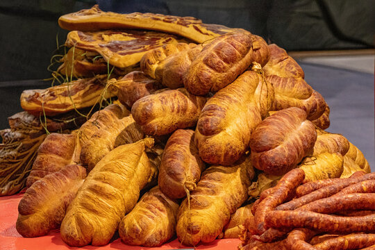 Large pile of fresh organic traditional homemade deli meat pork ham and sausages