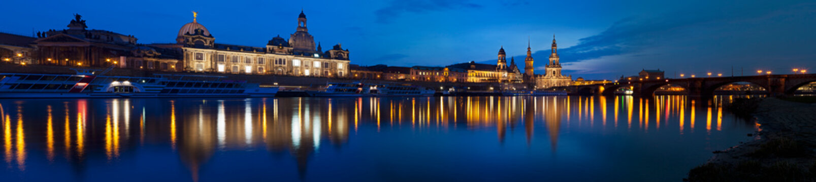 Germany, Saxony, Dresden, View of skyline of Staendehaus, Frauenkirche, Katholische Hofkirche, Semperoper, Bruehl's Terrace, Dresden Castle and Augustus bridge with Elbe waterfront at night