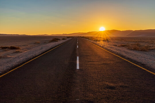 Africa, Namibia, Namib desert, Naukluft National Park, empty road at sunset