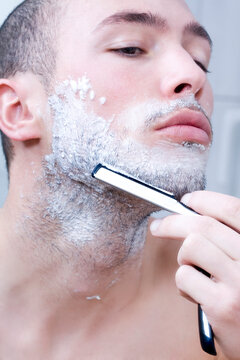 Man shaving with razor, close-up