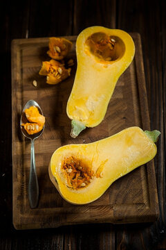 Deseeding a butternut squash, Cucurbita moschata, with a spoon