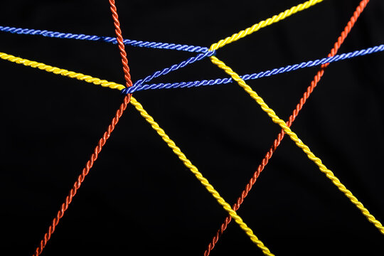 Connected ropes in front of black background