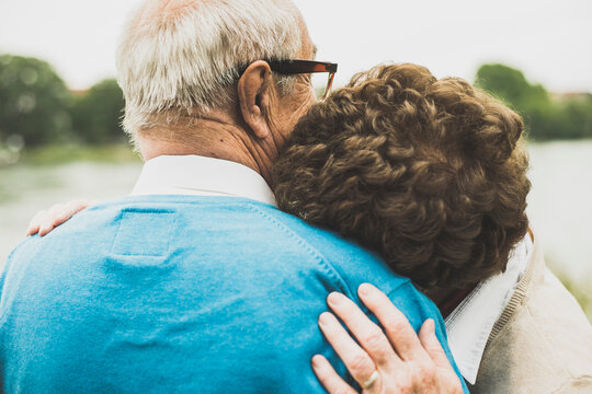 Senior woman with head on the shoulder of her husband