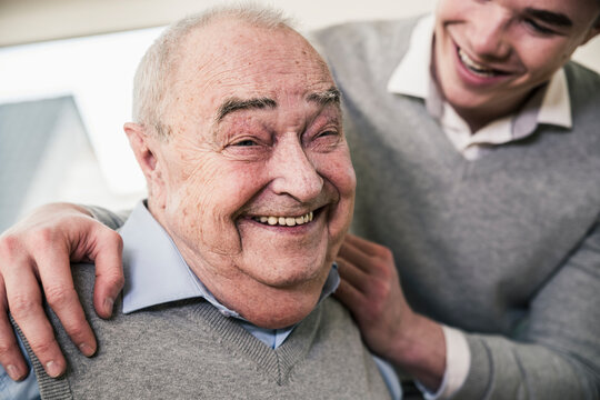 Portrait of happy senior man with young man
