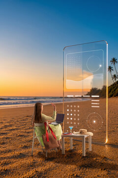 Woman interacting with transparent planning interface while working on laptop by ocean at sunset. Concept of virtual collaboration, planning software and flexible workplace.