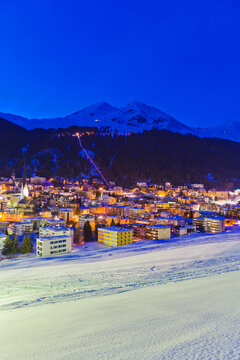 Snow covers the illuminated winter sports resort of Davos at night