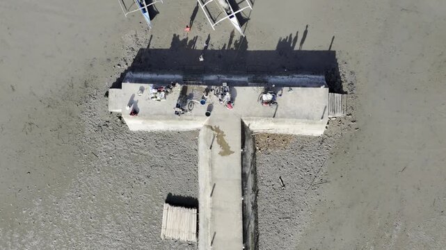 Aerial drone view of Fishing dock and shallow coastal water revealed at Inner Malampaya Sound, Taytay