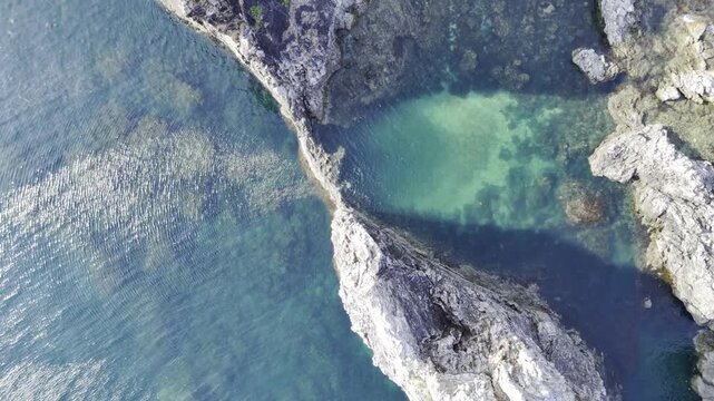 Aerial drone view of Turquoise lagoon and rocky cape at Camago Island in Taytay, Palawan