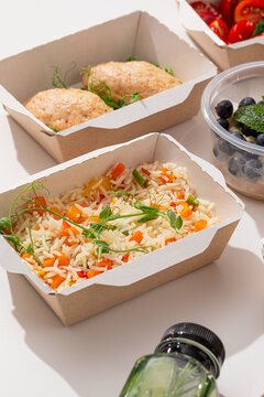Healthy food delivery meal boxes with steamed vegetable rice chicken cutlets oatmeal and detox water