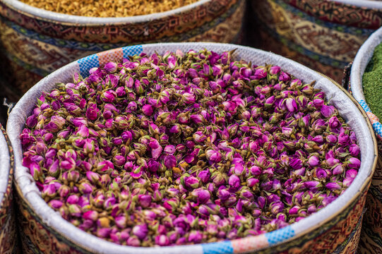 Dried damask rosebuds inside a traditional woven basket at a bazaar, Iran.