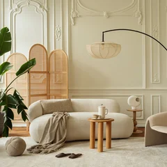 Elegant and cozy modern living room interior design with neutral cream color palette, comfortable curved sofa, stylish furniture, and warm lighting © FollowTheFlow