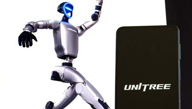 Unitree Logo Displayed on a Mobile Phone with a Humanoid Robot in the Background, Illustrating Chinese Robotics Technology