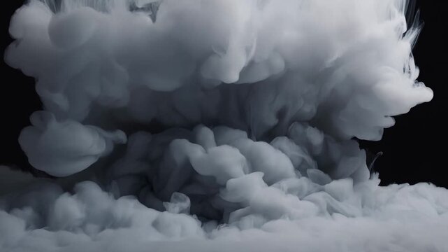 White smoke explosion stock video footage. Thick grey clouds billow and roll against a black background. Dramatic atmospheric motion for cinematic backgrounds, transitions, and abstract effects.