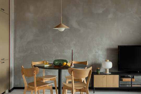 Modern dining space with wood chairs and soft lighting