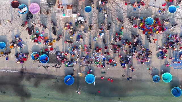Aerial view of morning seafood market on Doc Let beach, Khanh Hoa province with local vendors and baskets in Vietnam