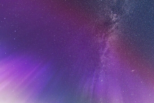 Purple Aurora Glow and Milky Way Across the Night Sky