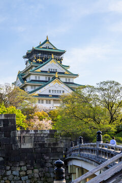 Osaka Castle, surrounded by moats, bridges and walls, is a 16th century masterpiece. Its intricate architecture, green roofs, and golden details showcase Edo period style