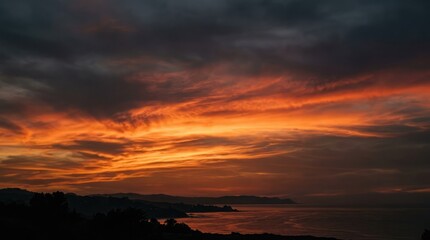 Fototapeta premium Dramatic fiery sunset over ocean waves with dark stormy sky above