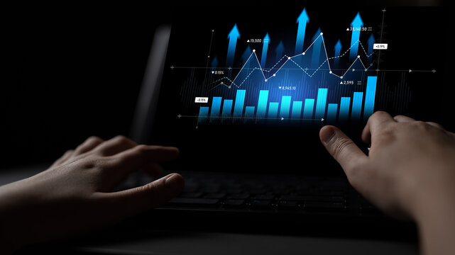 A close-up of hands interacting with a laptop displaying a vibrant data visualization of financial trends and analysis for informed business decisions. Scalp