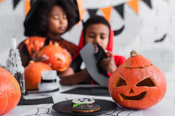Fototapeta premium Joyful siblings celebrate Halloween with fun costumes and festive decorations
