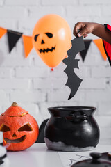 Fototapeta premium Creative Halloween fun with a child preparing for trick or treat adventures in autumn