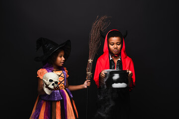 Fototapeta premium Joyful siblings celebrate Halloween in vibrant costumes, creating festive memories together