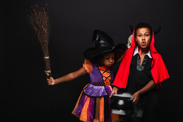 Fototapeta premium Exciting Halloween adventures with adorable siblings in vibrant costumes