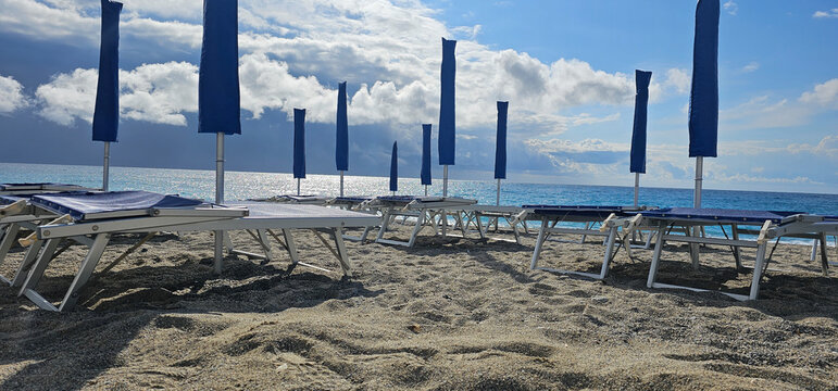 Deckchairs and umbrellas at a beach resort during a summer holiday