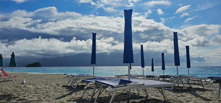Deckchairs and umbrellas at a beach resort during a summer holiday