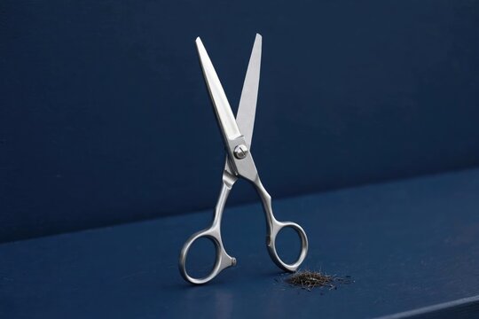Silver Scissors with Fabric Scraps on Navy Surface