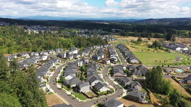 4K aerial drone footage of suburban neighborhood and residential housing in Camas, Washington, USA, showing single family homes, curved streets, real estate development and community layout