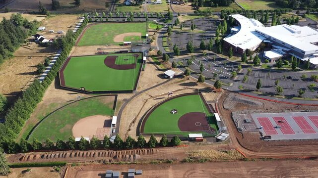 4K aerial drone footage of baseball and softball fields at Camas High School in Washington, USA, showing athletic facilities, sports diamonds, school campus and outdoor recreation complex