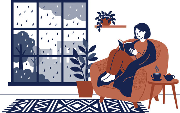 Woman reading a book in an armchair on a rainy day