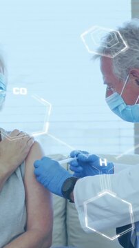 Animation of chemical formula over caucasian male doctor with patient holding vaccine