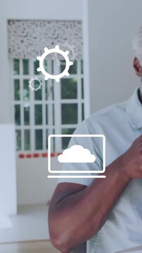 Drinking coffee and working on laptop, man with business icons animation over